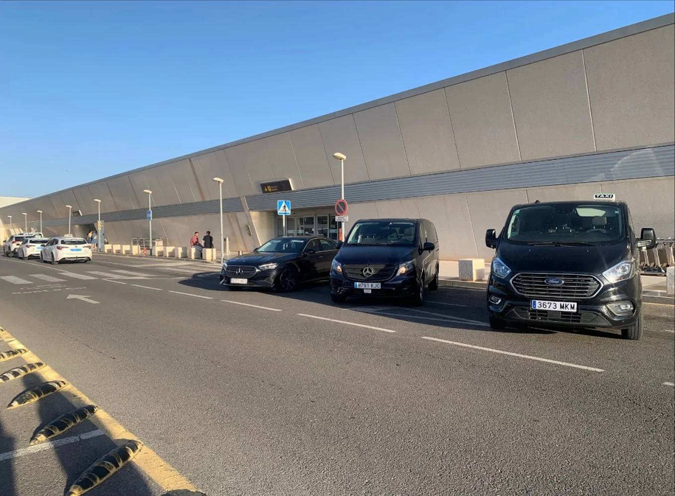 Autos & Taxi Indalo cars picking up passengers at the airport terminal